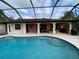 Inviting pool area with screened enclosure at 18345 Ohara Dr, Port Charlotte, FL 33948