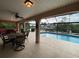 Relaxing pool area with covered patio and outdoor dining at 18345 Ohara Dr, Port Charlotte, FL 33948