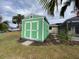 Green storage shed with double doors at 18345 Ohara Dr, Port Charlotte, FL 33948