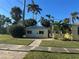 Small yellow house with a metal roof and small patio at 205 Chasteen St, Punta Gorda, FL 33950