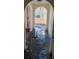 Hallway with arched doorways and damaged flooring at 205 Chasteen St, Punta Gorda, FL 33950