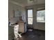 Small kitchen in need of renovation, showing damage and debris at 205 Chasteen St, Punta Gorda, FL 33950