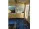 Living room with damaged flooring and a ceiling fan at 205 Chasteen St, Punta Gorda, FL 33950