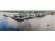 Aerial view of waterfront commercial property featuring several restaurants and a marina with boat slips at 210 Divinci Dr, Punta Gorda, FL 33950