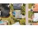 Aerial view highlighting the house with a pool, surrounded by lush landscaping and waterfront access at 210 Divinci Dr, Punta Gorda, FL 33950