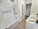 Beautiful bathroom showcasing the bathtub, rain shower head, and natural light at 210 Divinci Dr, Punta Gorda, FL 33950