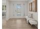 Bright entryway with light wood tile floors and a bench at 210 Divinci Dr, Punta Gorda, FL 33950