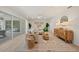 Inviting living room showcases a large rug, neutral furniture, and seamless indoor-outdoor flow to the lanai at 210 Divinci Dr, Punta Gorda, FL 33950