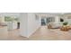 Open living room with light wood tile floors and access to patio at 210 Divinci Dr, Punta Gorda, FL 33950