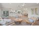 Open living room featuring modern furniture, bright kitchen, and natural light at 210 Divinci Dr, Punta Gorda, FL 33950