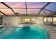 Stunning pool at sunset with screened enclosure at 210 Divinci Dr, Punta Gorda, FL 33950