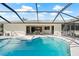 A sparkling screened-in pool area with a patio and comfortable seating offers a great spot to relax at 210 Divinci Dr, Punta Gorda, FL 33950