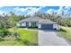 Single-story home with gray roof, white walls, and a paver driveway at 2137 Adirondack Ln, Port Charlotte, FL 33953