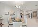 Bright dining area with glass table and seating for four, adjacent to kitchen at 2462 Gabel Oak Dr, North Port, FL 34289