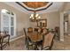 Dining room featuring a decorative ceiling, chandelier, and an adjacent breakfast bar at 2895 Mill Creek Rd, Port Charlotte, FL 33953