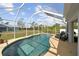 Inviting screened-in pool with lounge chairs at 3343 Sorrel St, Port Charlotte, FL 33981