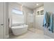 Relaxing bathroom with a soaking tub and walk-in shower at 3401 Sandpiper Dr, Punta Gorda, FL 33950