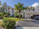 Condo building with parking and lush landscaping at 437 Cerromar Ln # 312, Venice, FL 34293