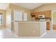 Kitchen features light wood cabinets, tile backsplash and a breakfast bar at 4605 Midland St, North Port, FL 34288