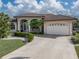 Single-story home with tile roof, attached garage, and manicured landscaping at 500 Andora Dr, Punta Gorda, FL 33950