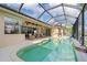 Relaxing pool and patio area with seating, screened enclosure, and outdoor kitchen at 500 Andora Dr, Punta Gorda, FL 33950