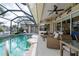 Relaxing screened-in pool area with patio furniture at 500 Andora Dr, Punta Gorda, FL 33950