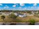 Aerial view of a home with a screened porch near the water at 5032 Koli Ct, North Port, FL 34287