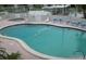 Community pool and spa featuring lounge chairs, clear water, and well-maintained surrounding area at 525 Parkwood Ave, North Port, FL 34287
