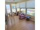 Bright and sunny sunroom with large windows offering views of the neighborhood at 525 Parkwood Ave, North Port, FL 34287