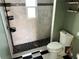 Updated bathroom with pebble flooring and a modern shower at 627 Palm Ave, Punta Gorda, FL 33950
