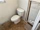 Bathroom with toilet and flooring needing updating at 627 Palm Ave, Punta Gorda, FL 33950