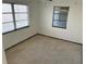 Simple bedroom with terrazzo flooring and dual pane windows at 627 Palm Ave, Punta Gorda, FL 33950