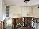 White cabinets and exposed plumbing in kitchen needing renovation at 627 Palm Ave, Punta Gorda, FL 33950