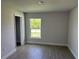 Bedroom showcasing tile flooring, window overlooking the outdoors, and a closet at 9506 Melody Cir, Port Charlotte, FL 33981