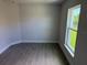 A bedroom with tile flooring and a window view of the outside at 9506 Melody Cir, Port Charlotte, FL 33981