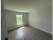 Bedroom featuring wood-look tile flooring and a window with a view of the outdoors at 9506 Melody Cir, Port Charlotte, FL 33981