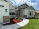Close-up of home featuring stone accents and a garden area near the front door, plus designer exterior lighting at 9506 Melody Cir, Port Charlotte, FL 33981