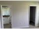 Hallway view of bathroom with granite counters and a closet with shelving at 9506 Melody Cir, Port Charlotte, FL 33981