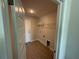Neutral laundry room with tiled floors, white walls, wire rack and a door to the exterior at 9506 Melody Cir, Port Charlotte, FL 33981