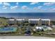 Aerial view of community with tennis courts, pool, and waterfront access at 101 N Marion Ct # 225, Punta Gorda, FL 33950