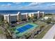 Aerial view of condo building with tennis court and waterfront access at 101 N Marion Ct # 225, Punta Gorda, FL 33950