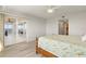 Bright bedroom with wood-look floors and sliding doors to balcony at 101 N Marion Ct # 225, Punta Gorda, FL 33950