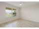 Bright bedroom with tile flooring, large window, and ceiling fan at 101 N Marion Ct # 225, Punta Gorda, FL 33950