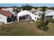 House with screened patio, grassy yard, and trees at 10208 Arrowhead Dr, Punta Gorda, FL 33955