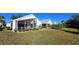 Spacious backyard with screened patio and lush lawn at 10208 Arrowhead Dr, Punta Gorda, FL 33955