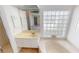 Bathroom with soaking tub, walk-in shower and a glass block window at 10208 Arrowhead Dr, Punta Gorda, FL 33955