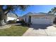 Front view of a single-story home with a white exterior and a two-car garage at 10208 Arrowhead Dr, Punta Gorda, FL 33955