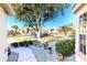 Landscaped front yard with a walkway and mature trees at 10208 Arrowhead Dr, Punta Gorda, FL 33955