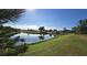 Peaceful lakefront view with mature trees at 10208 Arrowhead Dr, Punta Gorda, FL 33955