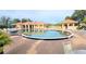 Kidney-shaped community pool with lounge chairs at 10208 Arrowhead Dr, Punta Gorda, FL 33955